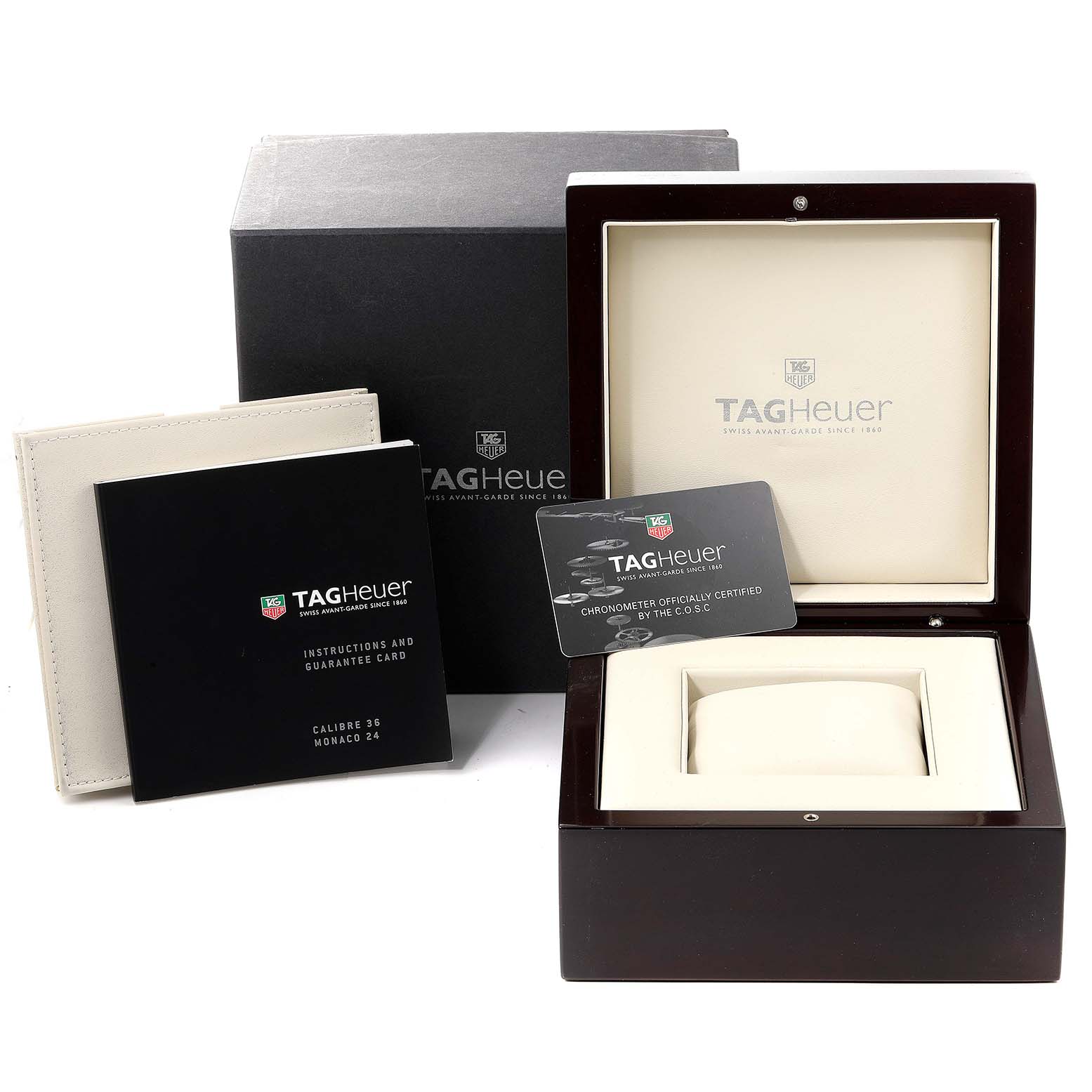 The image shows the packaging and accessories for a Tag Heuer Monaco CAL5111.FC6299 Men
s Stainless Steel Blue Dial CAL5111.FC6299 Men
s Stainless Steel Blue Dial watch, including the box, manual, and guarantee card.