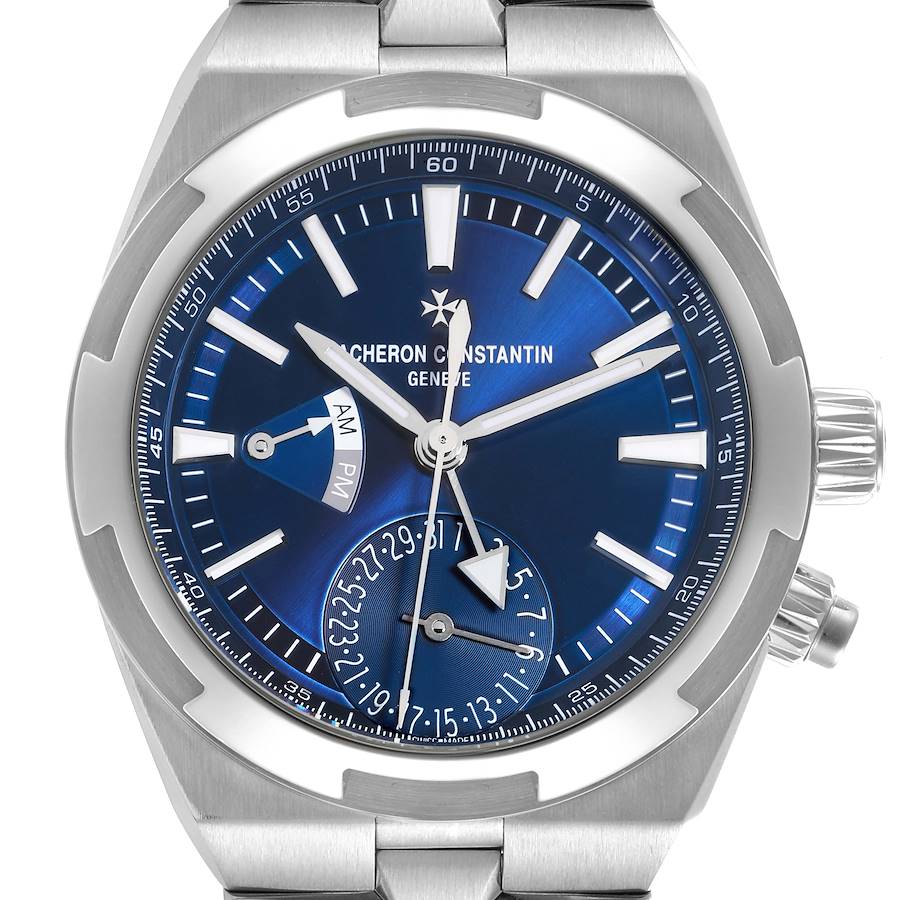 The Vacheron Constantin Overseas watch is shown from the front, displaying the blue dial, hour markers, hands, date, and AM/PM indicators.