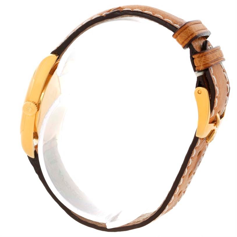 This image shows a side angle of a Rolex Cellini 6229 Women's Yellow Gold White Dial 6229 Women's Yellow Gold White Dial watch, highlighting the gold crown and brown leather strap.