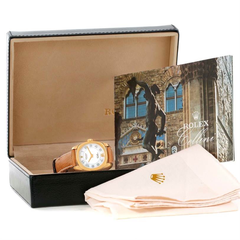 This image shows a Rolex Cellini 6229 Women's Yellow Gold White Dial 6229 Women's Yellow Gold White Dial watch in its box, accompanied by a booklet and a cloth, viewed from a front angle.