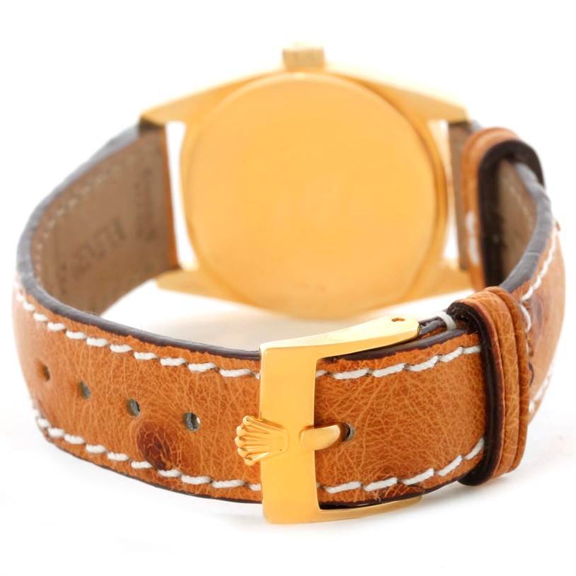 The image shows the back of a Rolex Cellini 6229 Women's Yellow Gold White Dial 6229 Women's Yellow Gold White Dial watch, highlighting the leather strap and the gold buckle with the Rolex logo.