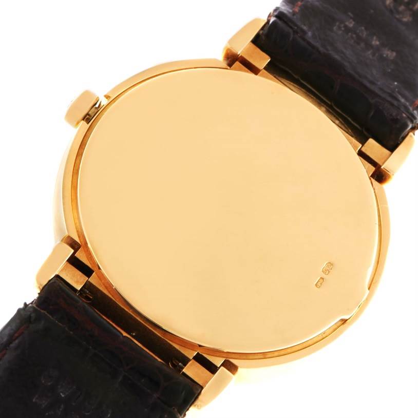 This image shows the back case of a Rolex Cellini 6622 Women's Yellow Gold White Dial 6622 Women's Yellow Gold White Dial watch with its leather strap and gold finish.