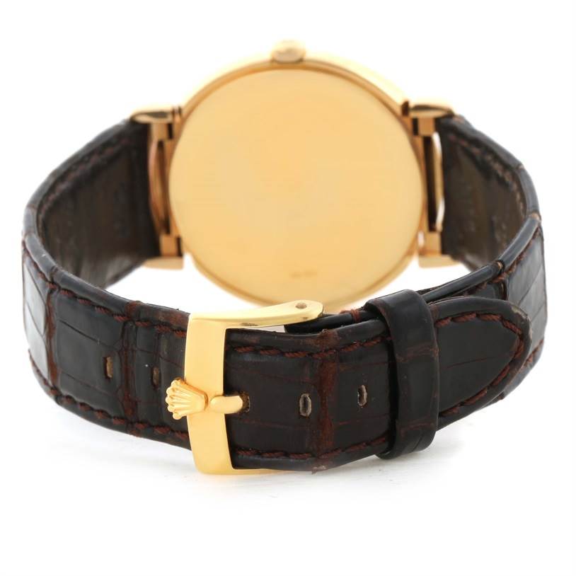 This image shows the rear view of a Rolex Cellini 6622 Women's Yellow Gold White Dial 6622 Women's Yellow Gold White Dial watch displaying its gold case and leather strap with a gold buckle.