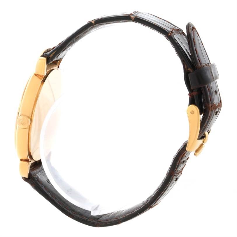 The Rolex Cellini 6622 Women's Yellow Gold White Dial 6622 Women's Yellow Gold White Dial watch is shown from a side angle, featuring a gold case and a brown leather strap with a clasp.