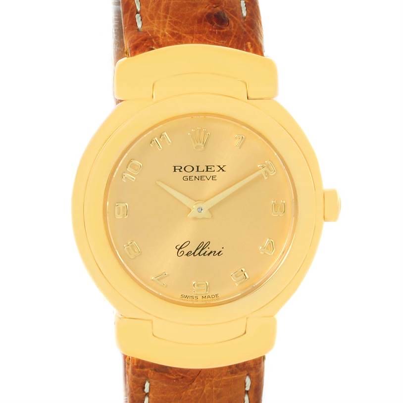 The Rolex Cellini watch is shown from the front, highlighting its golden dial, case, and brown leather strap.