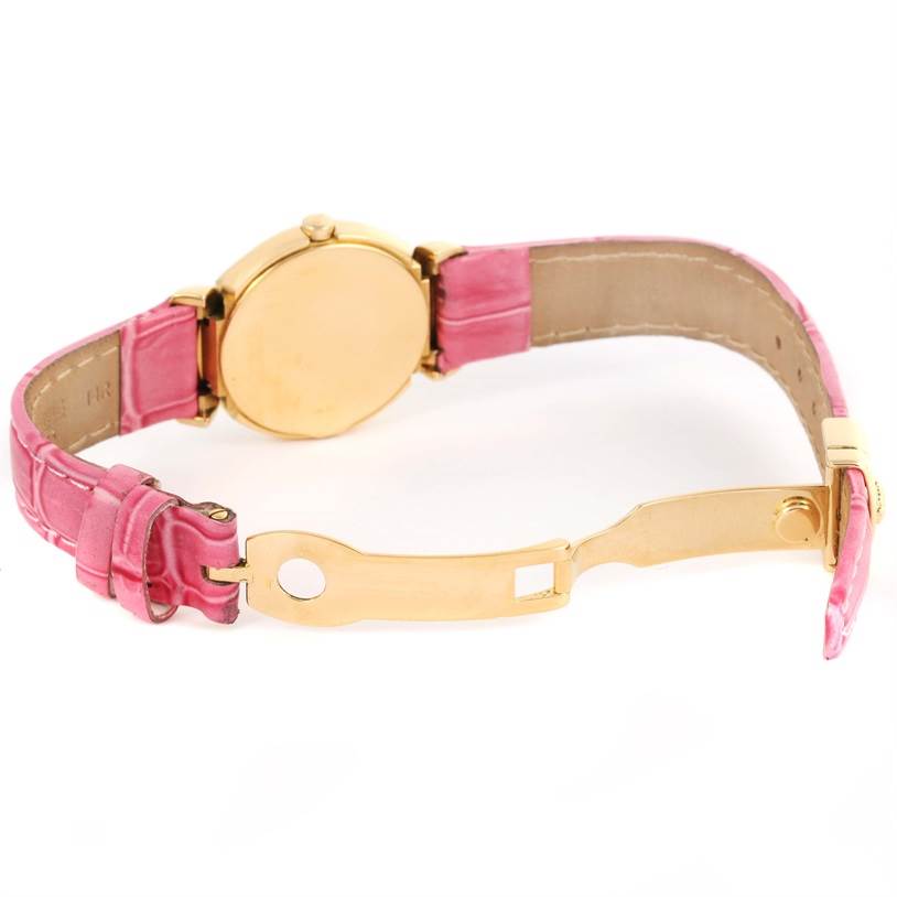 This image shows a Rolex Cellini 6621 Women's Yellow Gold Beige Dial 6621 Women's Yellow Gold Beige Dial watch from the back, highlighting its gold case, pink strap, and open clasp.