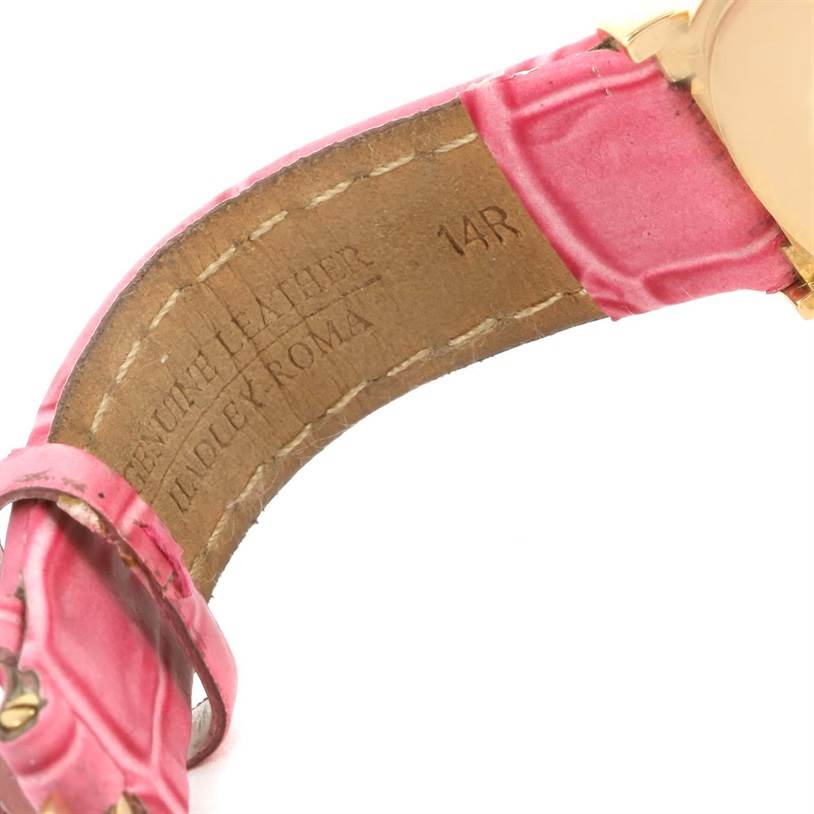 The image shows the underside of the leather strap on a Rolex Cellini 6621 Women's Yellow Gold Beige Dial 6621 Women's Yellow Gold Beige Dial watch, featuring pink stitching and engravings.