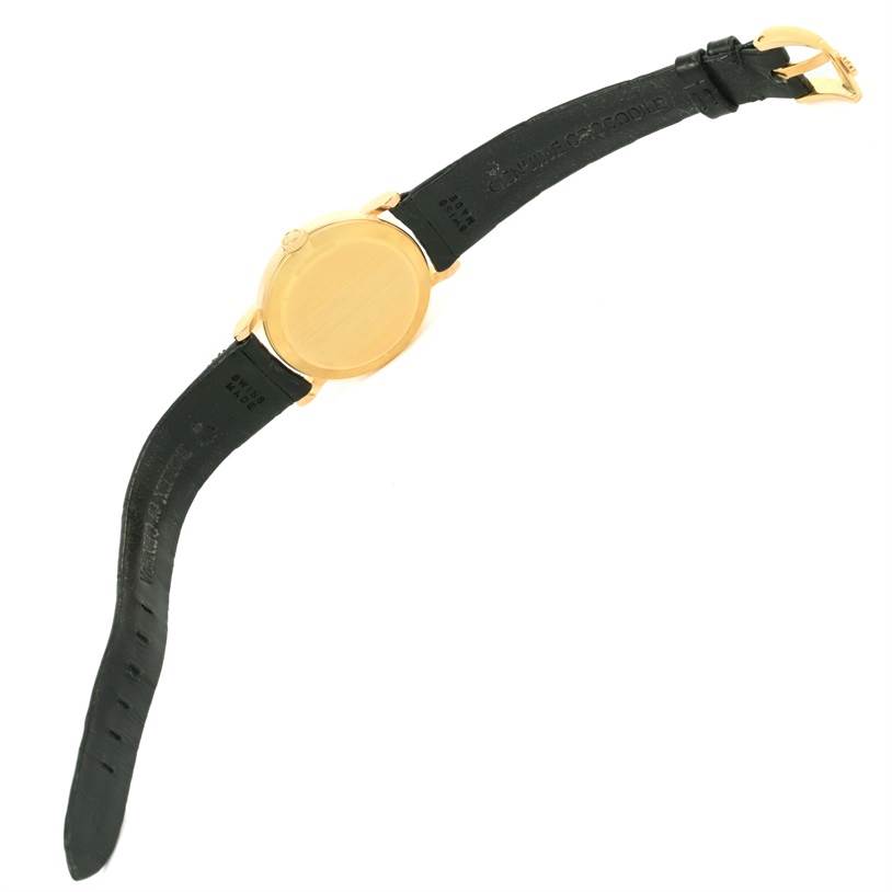 The Rolex Cellini 5109 Women's Yellow Gold Beige Dial 5109 Women's Yellow Gold Beige Dial watch is shown from the back, highlighting its gold case and black leather strap with a gold buckle.