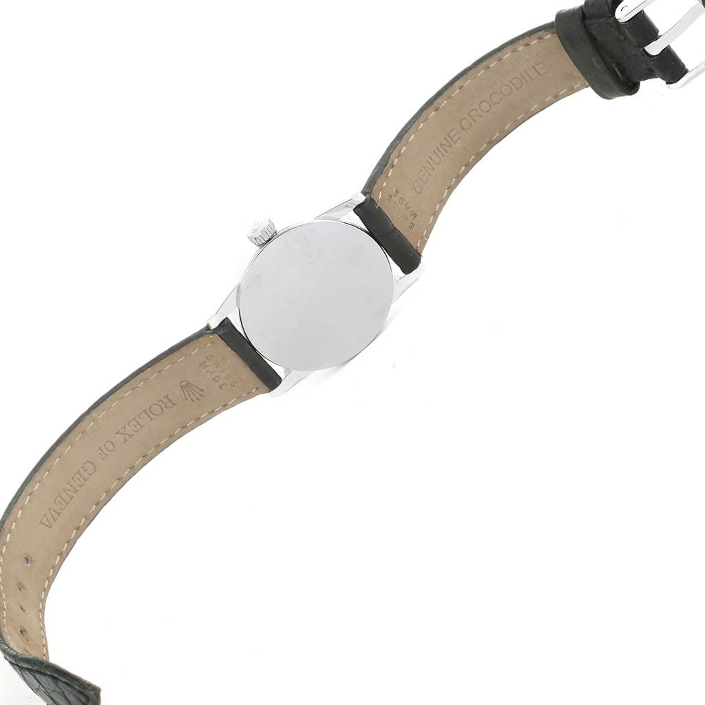 The image shows the back of a Rolex Cellini 6111 Women's White Gold Black Dial 6111 Women's White Gold Black Dial watch, focusing on the case back and the leather strap with "GENUINE CROCODILE" embossed.