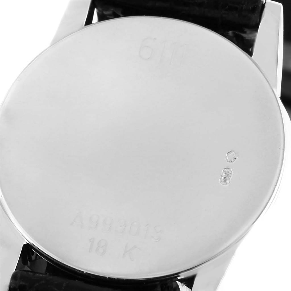 The image shows the back case of a Rolex Cellini 6111 Women's White Gold Black Dial 6111 Women's White Gold Black Dial watch, displaying engravings and markings.