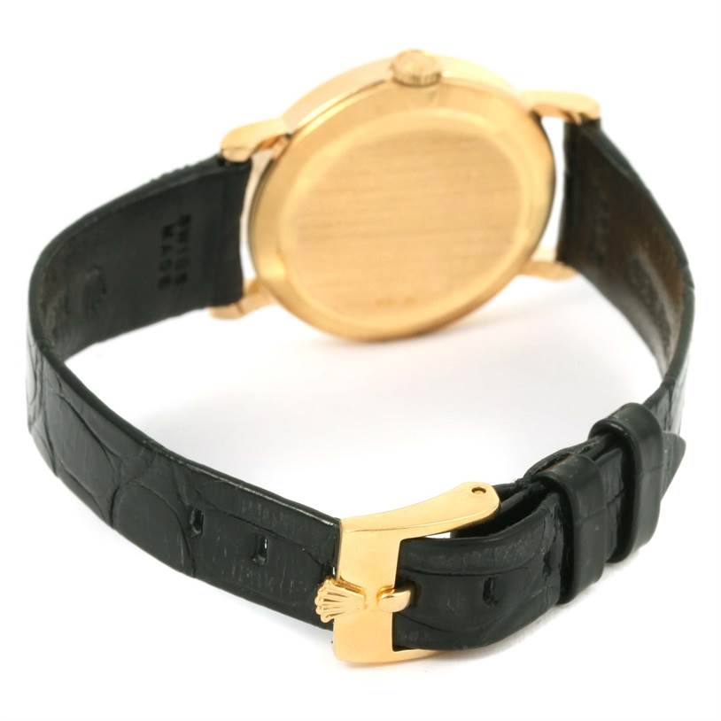 The image shows the back of a Rolex Cellini 5109 Women's Yellow Gold Beige Dial 5109 Women's Yellow Gold Beige Dial watch, highlighting its gold case, black leather strap, and gold buckle clasp.