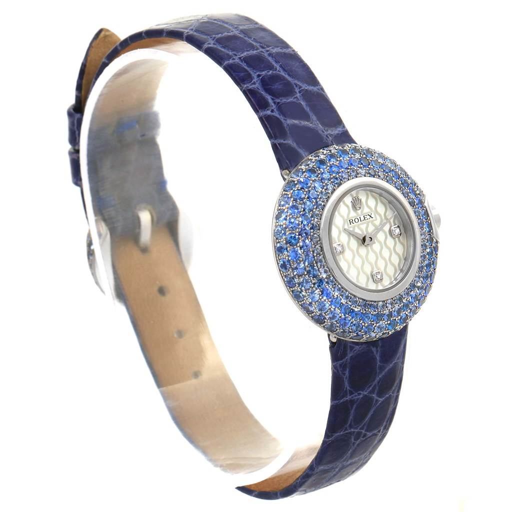 The image shows a Rolex Cellini 6201 Women's White Gold Mother of Pearl Dial 6201 Women's White Gold Mother of Pearl Dial watch from a side angle, displaying its blue strap and jeweled bezel.