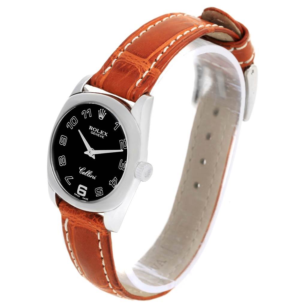 The Rolex Cellini 6229 Women's White Gold Black Dial 6229 Women's White Gold Black Dial watch is shown at an angled perspective displaying its brown leather strap and black dial with silver-tone numbers.