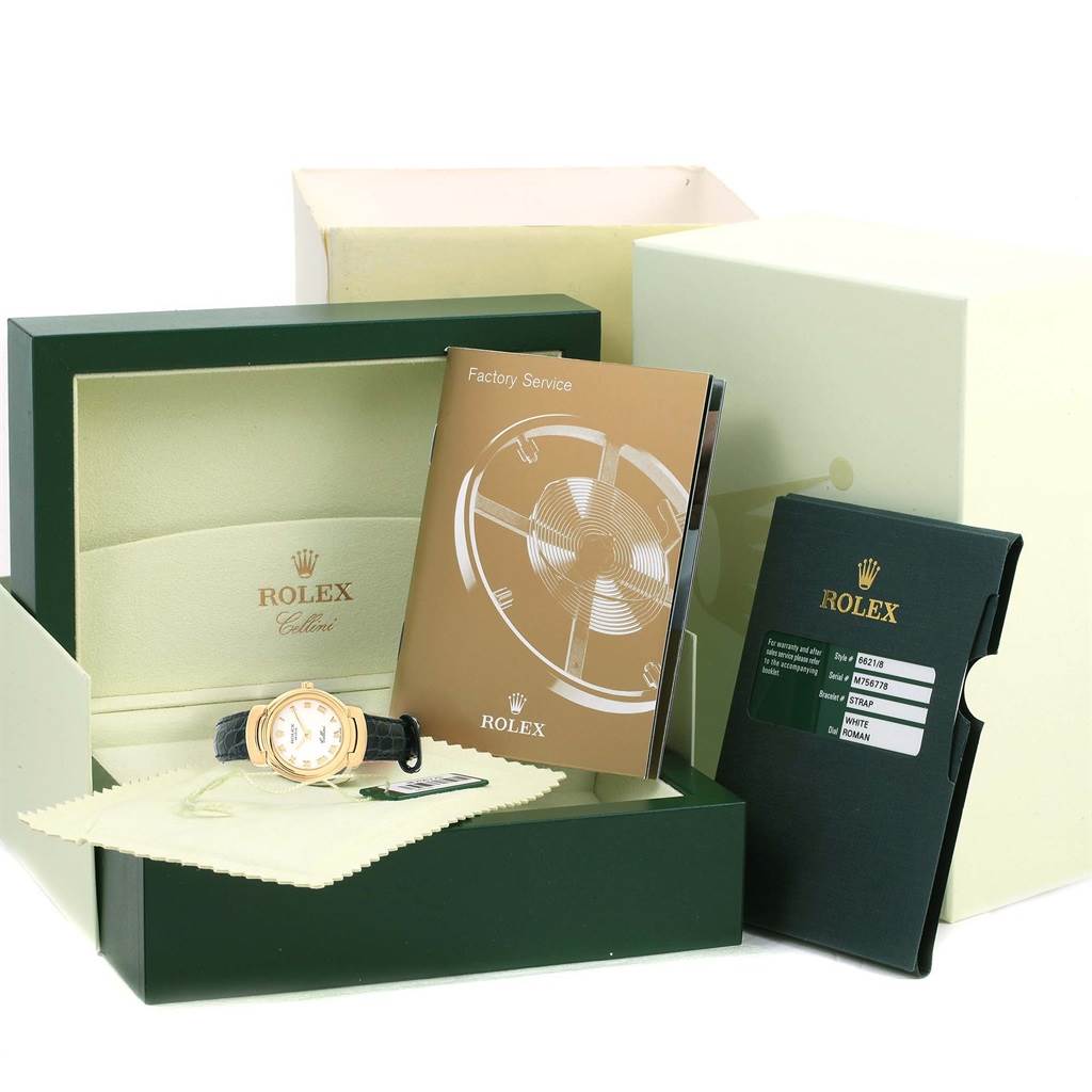 The image shows a Rolex Cellini 6621 Women's Yellow Gold White Dial 6621 Women's Yellow Gold White Dial watch with its original box, factory service manual, and warranty card.