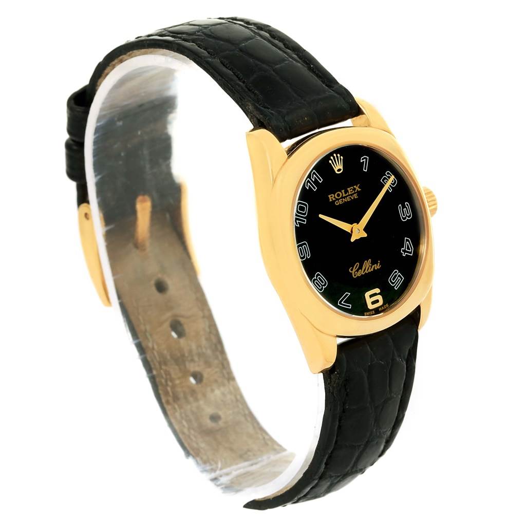 The image shows a Rolex Cellini 6229 Women's Yellow Gold Black Dial 6229 Women's Yellow Gold Black Dial watch at a tilted angle, highlighting its black dial, gold case, and black leather strap.