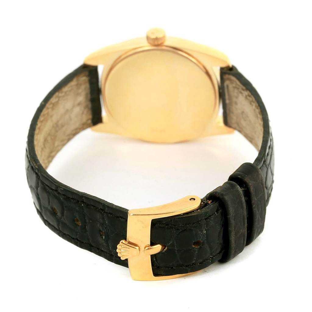 The image shows the back view of a Rolex Cellini 6229 Women's Yellow Gold Black Dial 6229 Women's Yellow Gold Black Dial watch, highlighting its leather strap and gold clasp.