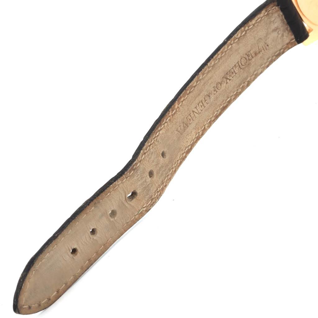 The image displays a close-up of the leather strap of a Rolex Cellini 6229 Women's Yellow Gold Black Dial 6229 Women's Yellow Gold Black Dial watch, focusing on the buckle end with the Rolex engraving.