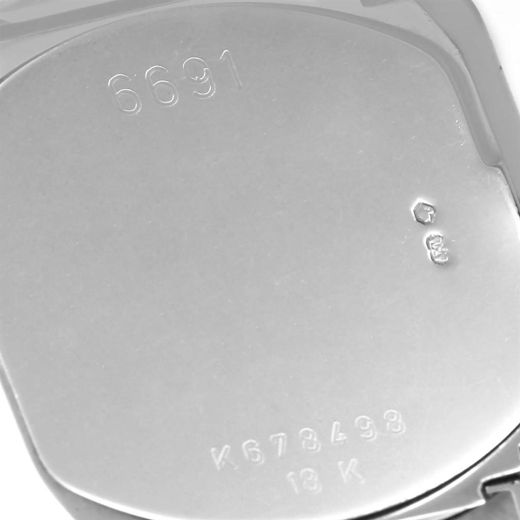 This image shows the back case of a Rolex Cellini 6691 Women
s White Gold Blue Dial 6691 Women
s White Gold Blue Dial watch, featuring serial numbers and hallmarks.