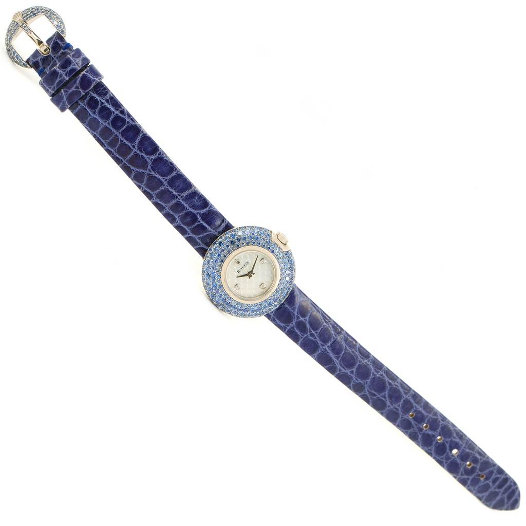 A Rolex Cellini 6201 Women's White Gold Mother of Pearl Dial 6201 Women's White Gold Mother of Pearl Dial watch is shown fully extended with a blue strap and jeweled bezel, viewed from above.