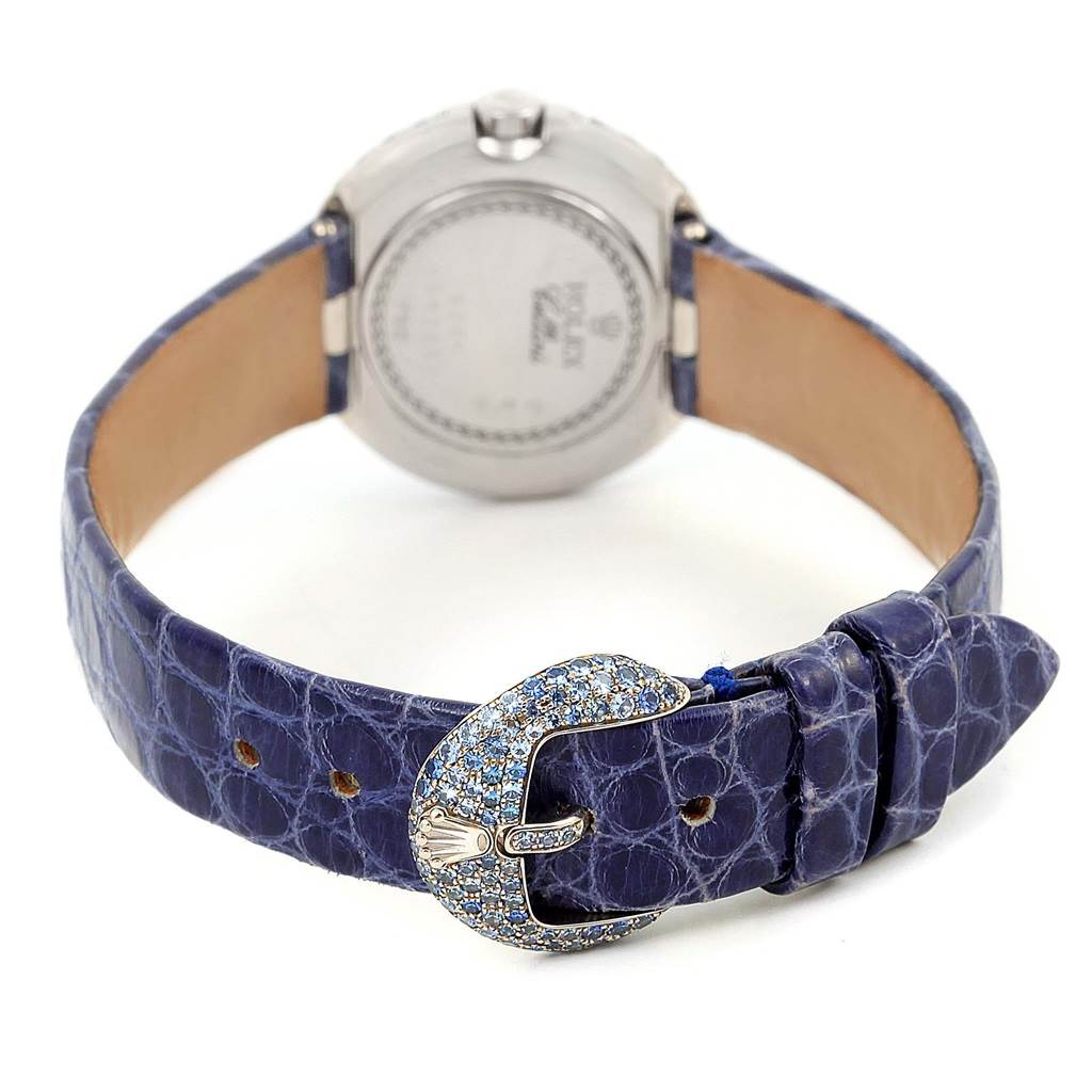 The image shows the back of a Rolex Cellini 6201 Women's White Gold Mother of Pearl Dial 6201 Women's White Gold Mother of Pearl Dial watch with a blue strap and a jeweled buckle.