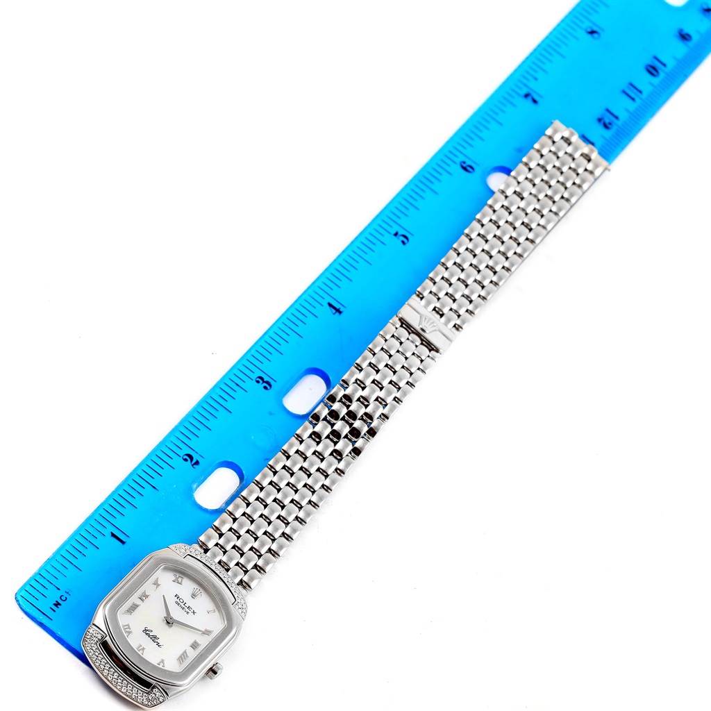 The Rolex Cellini 6692 Women's White Gold Mother of Pearl Dial 6692 Women's White Gold Mother of Pearl Dial watch is shown from a top-down angle with its face, band, and a ruler for scale.