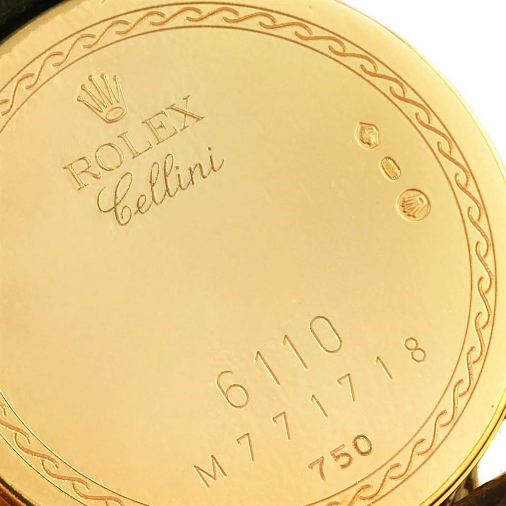 The image shows the back case of a Rolex Cellini 6110 Women's Yellow Gold Grey Dial 6110 Women's Yellow Gold Grey Dial watch with engravings of the brand, model, and serial numbers.