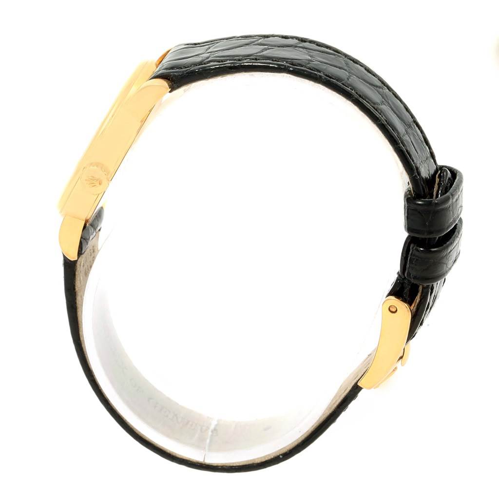 The Rolex Cellini 6110 Women's Yellow Gold Grey Dial 6110 Women's Yellow Gold Grey Dial watch is shown from a top-angle view, highlighting its black leather strap and gold clasp.