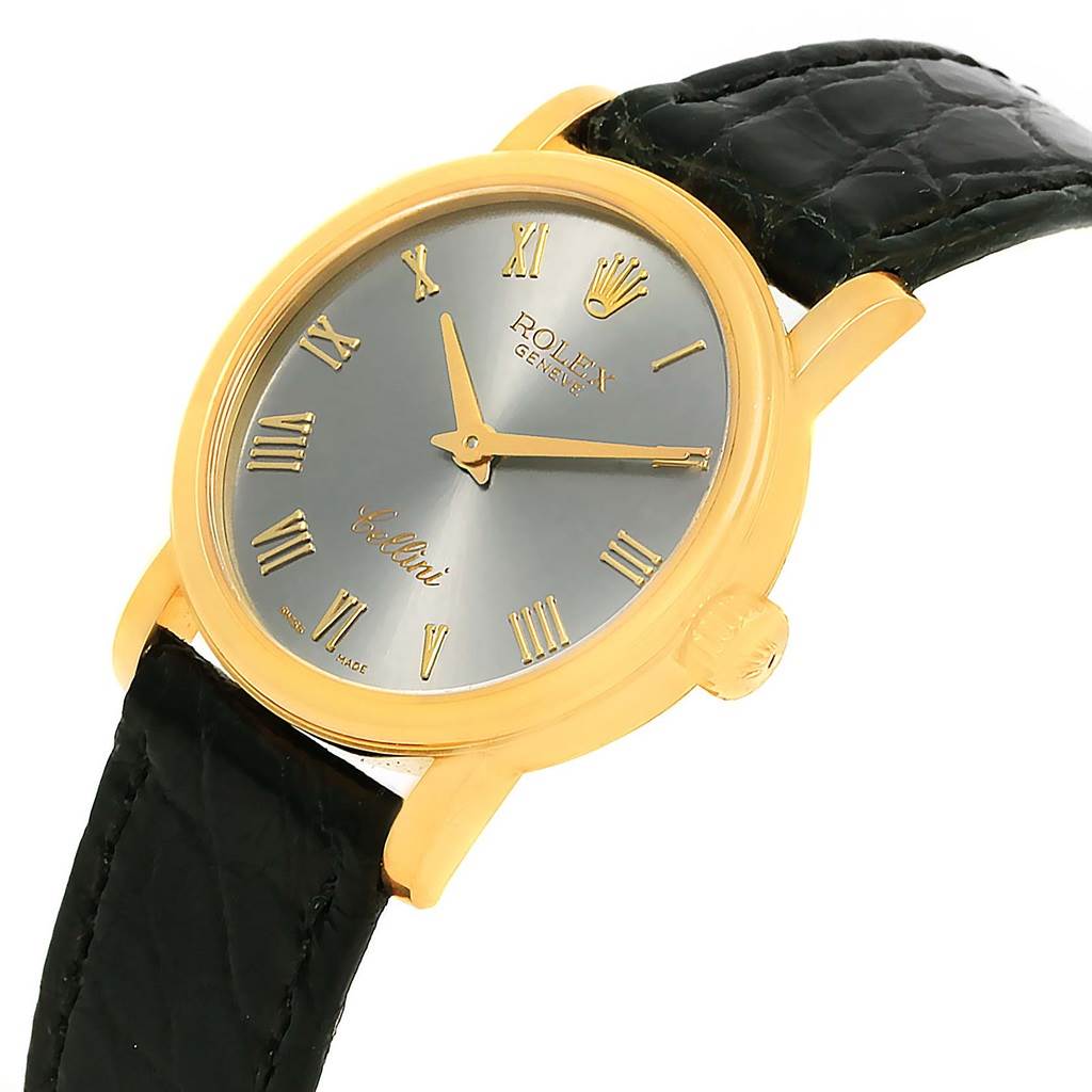 The Rolex Cellini 6110 Women's Yellow Gold Grey Dial 6110 Women's Yellow Gold Grey Dial watch is shown at an angled view, displaying its golden case, dial, black strap, and Roman numeral markers.