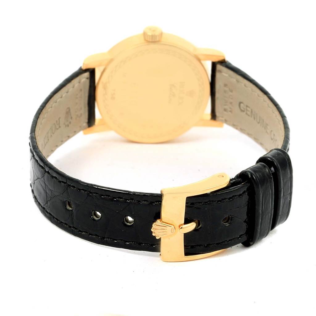 This image shows the back of a Rolex Cellini 6110 Women's Yellow Gold Grey Dial 6110 Women's Yellow Gold Grey Dial watch, highlighting its case, crown, and black leather strap with a gold buckle.