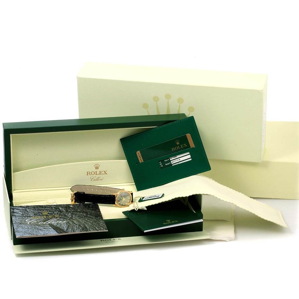 The image shows a Rolex Cellini 6110 Women's Yellow Gold Grey Dial 6110 Women's Yellow Gold Grey Dial model watch from a top angle, along with its box, warranty card, and manuals.