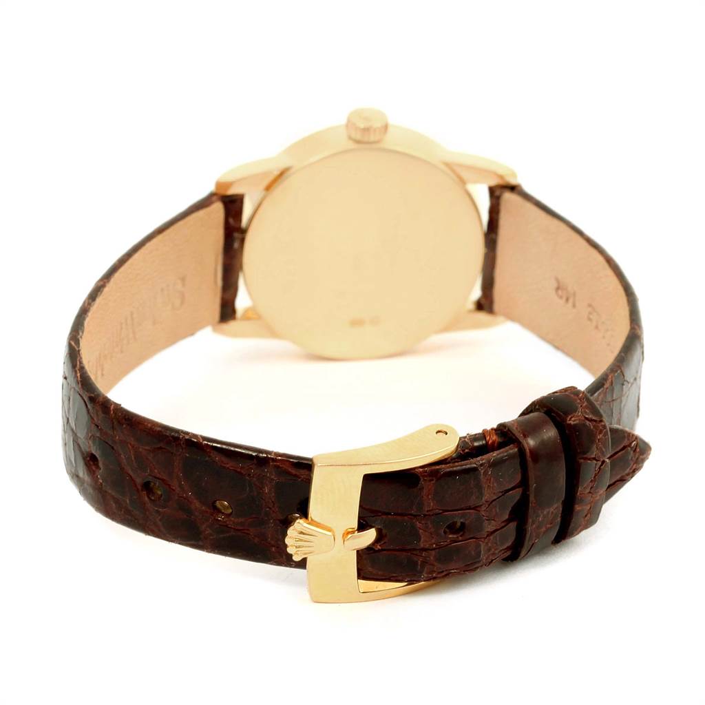 The image shows the back view of a Rolex Cellini 6111 Women's Yellow Gold Grey Dial 6111 Women's Yellow Gold Grey Dial watch, highlighting its closed caseback and brown leather strap with a gold buckle.