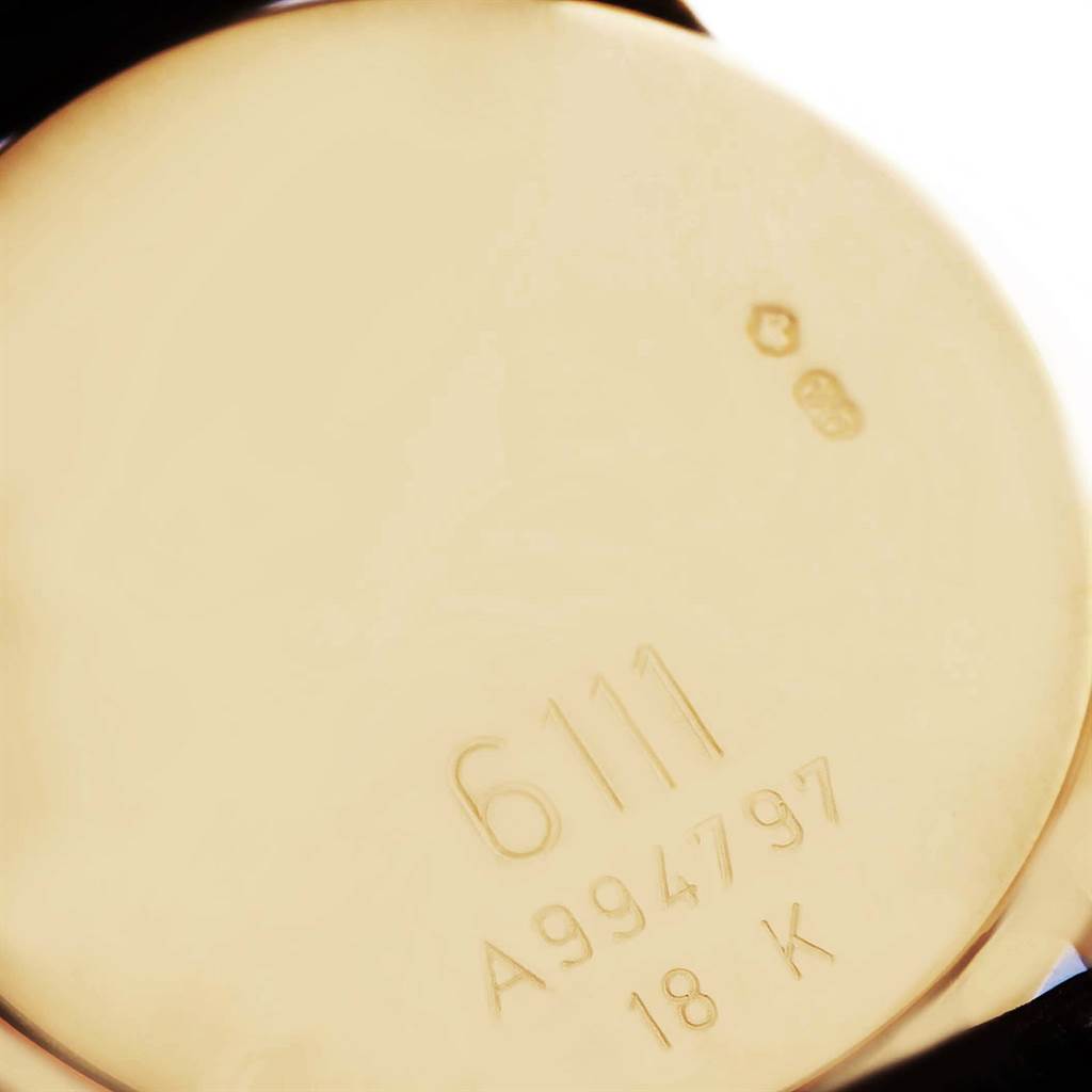 This image shows the back case of a Rolex Cellini 6111 Women's Yellow Gold Grey Dial 6111 Women's Yellow Gold Grey Dial watch, displaying engraving details including the model, serial number, and 18K gold mark.