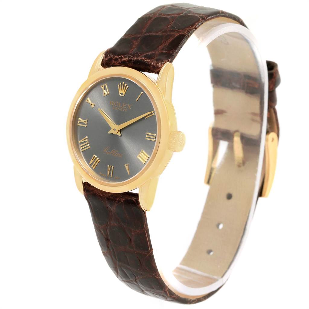 The Rolex Cellini 6111 Women's Yellow Gold Grey Dial 6111 Women's Yellow Gold Grey Dial watch is shown at a three-quarter angle, displaying its dial, bezel, crown, and leather strap.