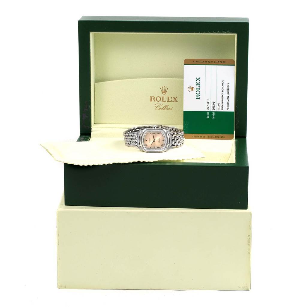 The image shows a Rolex Cellini 6693 Women
s White Gold Pink Dial 6693 Women
s White Gold Pink Dial watch from a front angle inside its open box, accompanied by documentation.