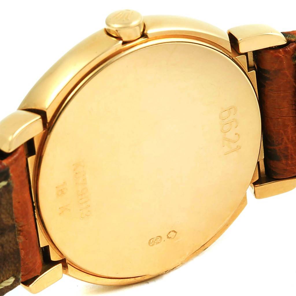 This image shows the back case and side view of the Rolex Cellini 6621 Women's Yellow Gold White Dial 6621 Women's Yellow Gold White Dial watch with part of the leather strap.