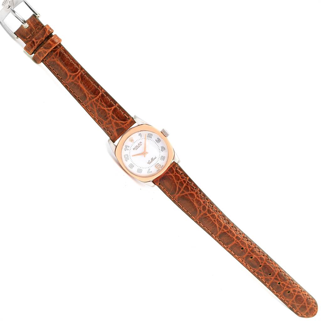 This image shows a Rolex Cellini 6229 Women's White Gold White Dial 6229 Women's White Gold White Dial watch from a top-down angle, featuring its face, bezel, and brown leather strap.