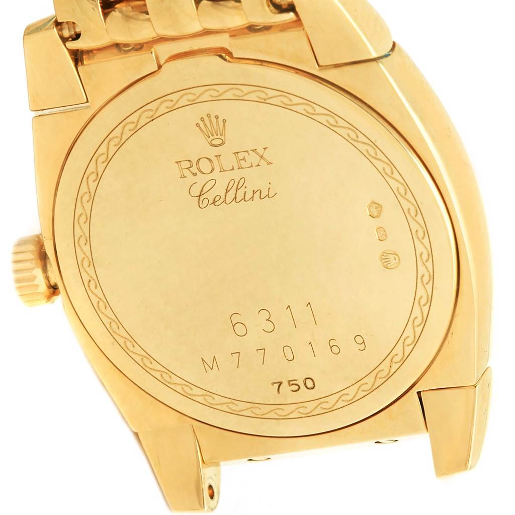 The image shows the back of a Rolex Cellini 6311 Women's Yellow Gold Mother of Pearl Dial 6311 Women's Yellow Gold Mother of Pearl Dial watch, highlighting its inscriptions and hinge.