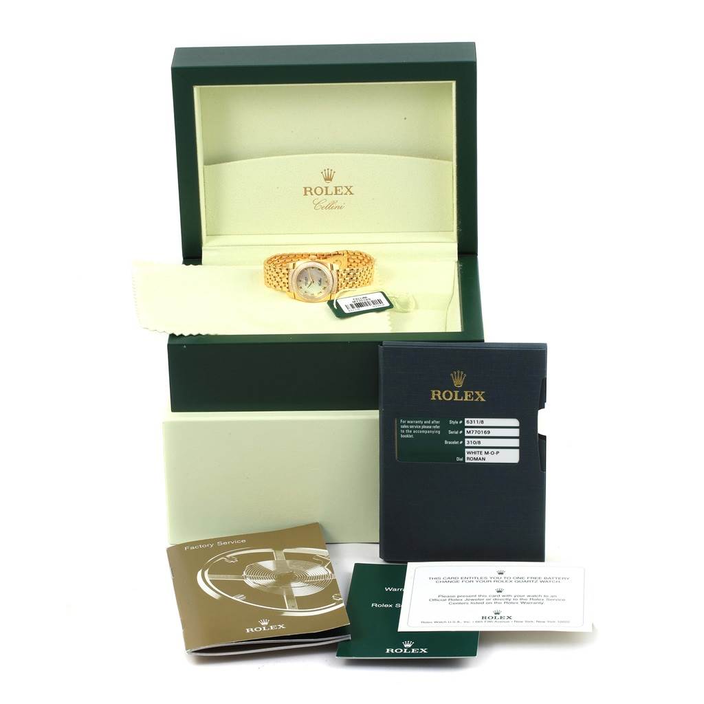 The image shows a Rolex Cellini 6311 Women's Yellow Gold Mother of Pearl Dial 6311 Women's Yellow Gold Mother of Pearl Dial watch inside an open box, along with booklets and a warranty card.