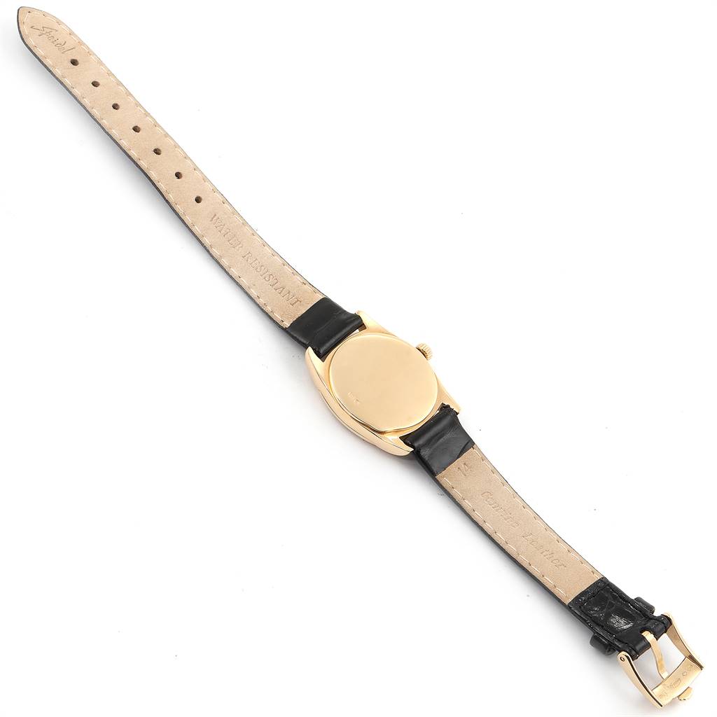 The image shows the back case and leather strap of a Rolex Cellini 6229 Women
s Yellow Gold White Dial 6229 Women
s Yellow Gold White Dial watch from a top-down angle.