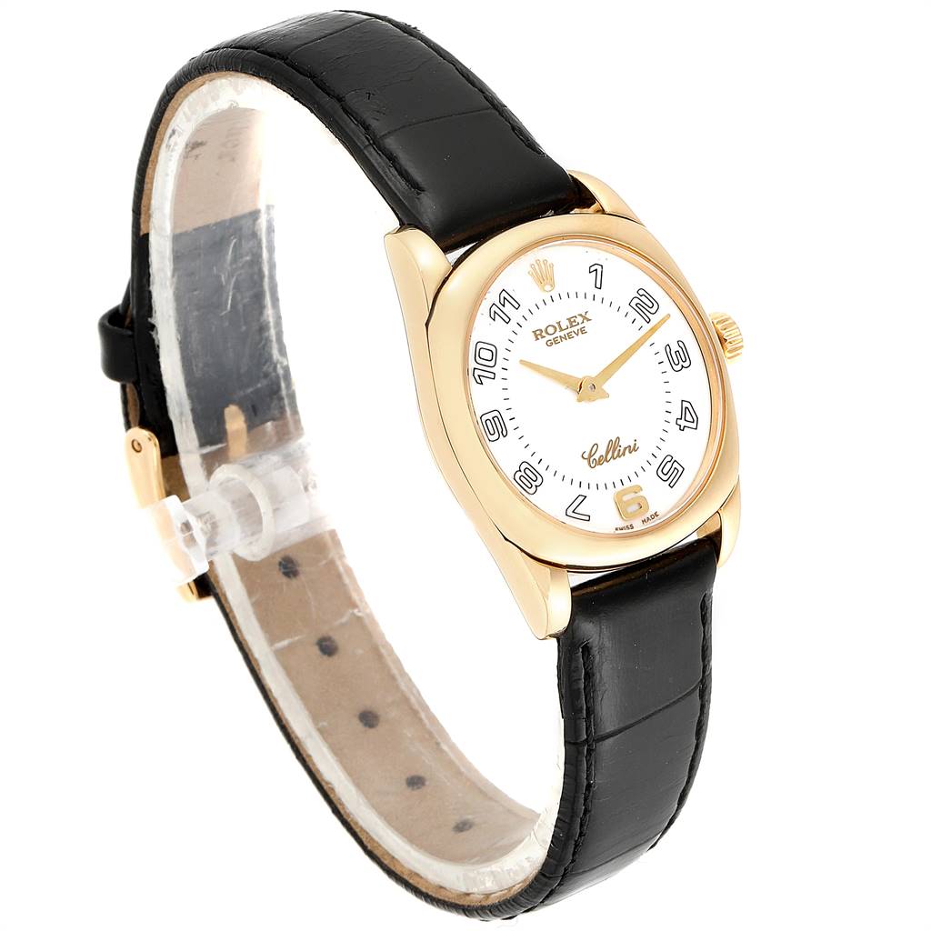 The image shows an angled side view of the Rolex Cellini 6229 Women
s Yellow Gold White Dial 6229 Women
s Yellow Gold White Dial watch, highlighting its face, gold case, and black leather strap.
