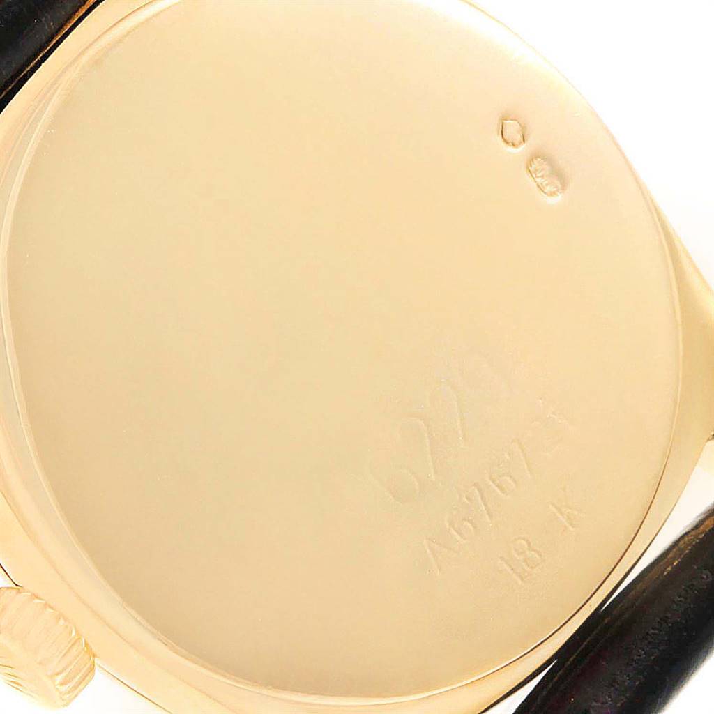 The image shows the rear caseback and part of the crown of a Rolex Cellini 6229 Women
s Yellow Gold White Dial 6229 Women
s Yellow Gold White Dial watch.