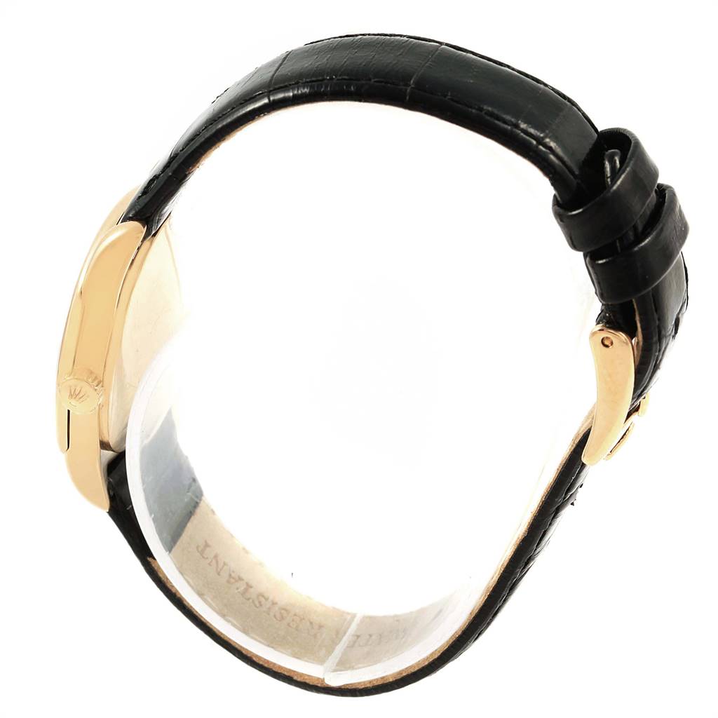 This image shows a side view of a Rolex Cellini 6229 Women
s Yellow Gold White Dial 6229 Women
s Yellow Gold White Dial watch, highlighting the black leather strap and gold clasp.