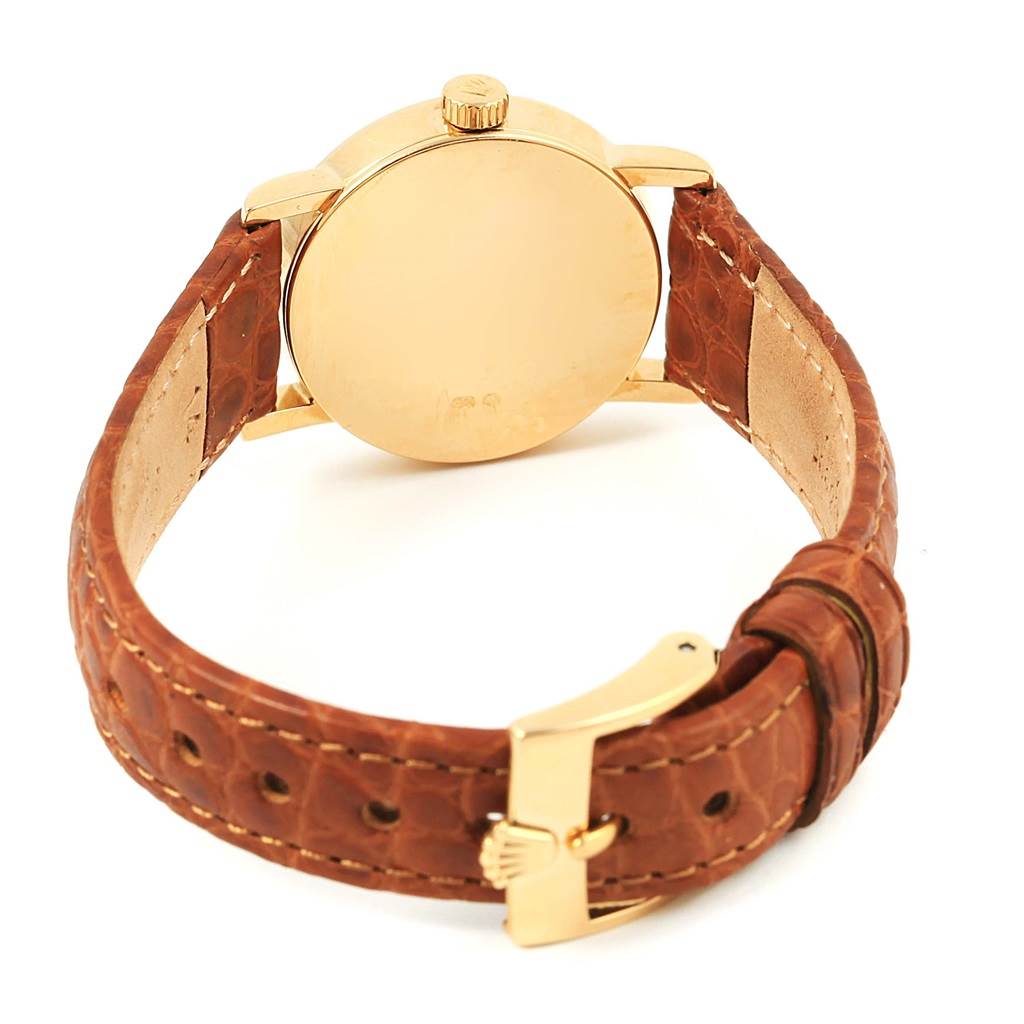 This image shows the back view of a Rolex Cellini 6610 Women's Yellow Gold Silver Dial 6610 Women's Yellow Gold Silver Dial watch, displaying the case back, crown, and leather strap with a buckle.