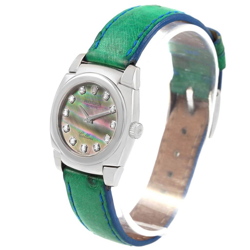 The Rolex Cellini 5310 Women's White Gold Mother of Pearl Dial 5310 Women's White Gold Mother of Pearl Dial watch is shown at an angled side view, displaying its dial, case, and green leather strap.