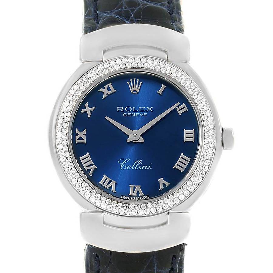 The image shows a frontal view of the Rolex Cellini watch, highlighting its blue dial, Roman numerals, and diamond-studded bezel.