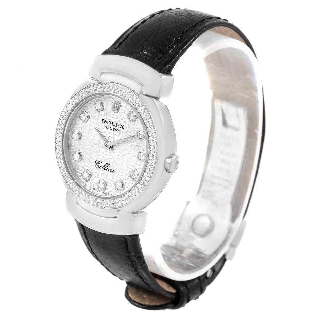 The Rolex Cellini 6671 Women
s White Gold Silver Dial 6671 Women
s White Gold Silver Dial watch is displayed at an angled side view showing the face, bezel, crown, and leather strap.