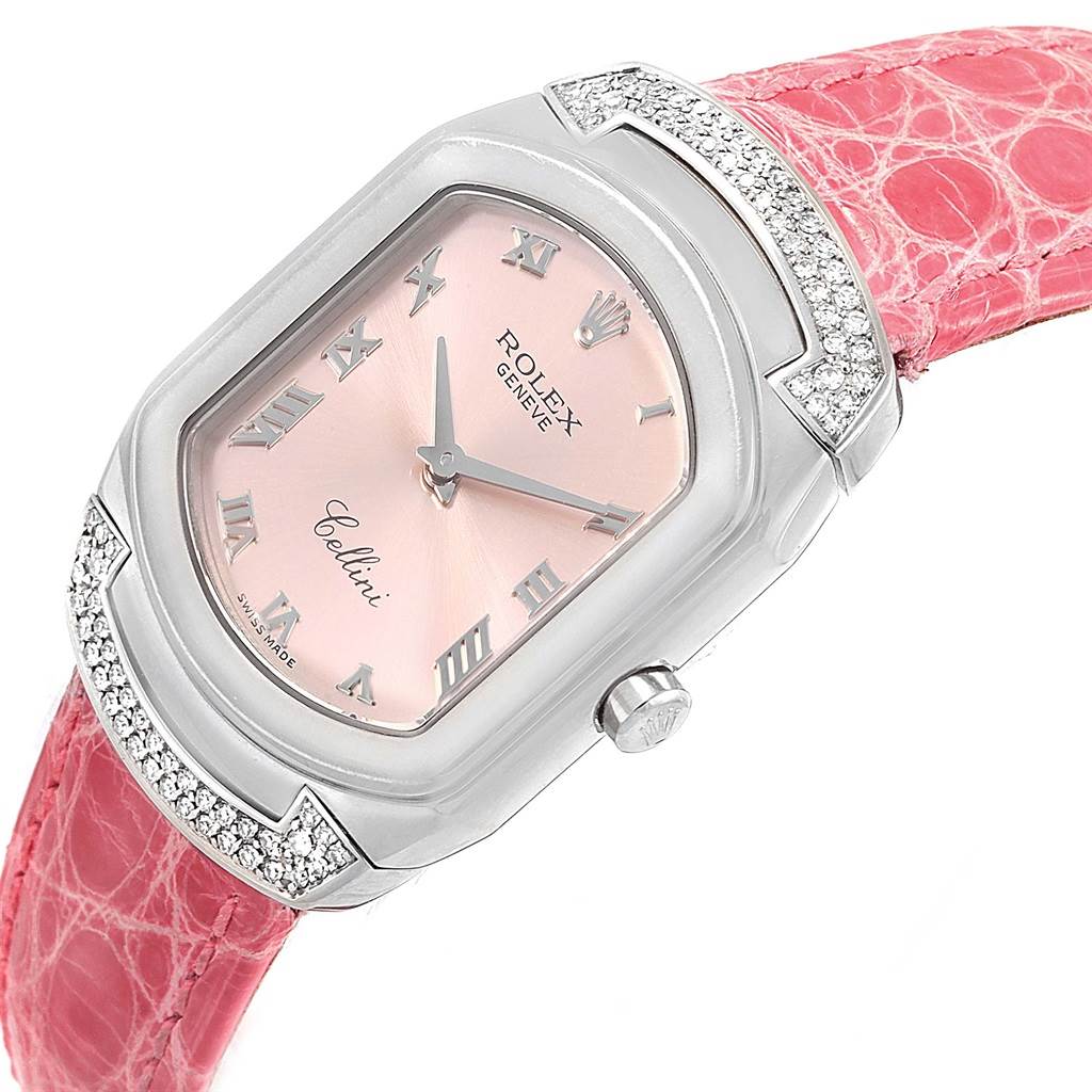 The image shows a close-up of a Rolex Cellini 6692 Women
s White Gold Pink Dial 6692 Women
s White Gold Pink Dial watch with a pink dial and pink strap.