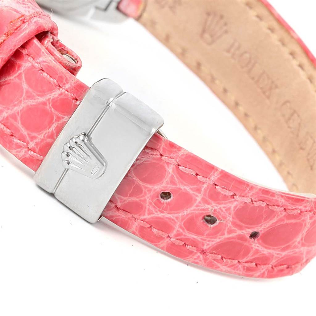 This image displays a close-up of the pink leather strap and clasp, showing the Rolex logo, of a Cellini model by Rolex.
