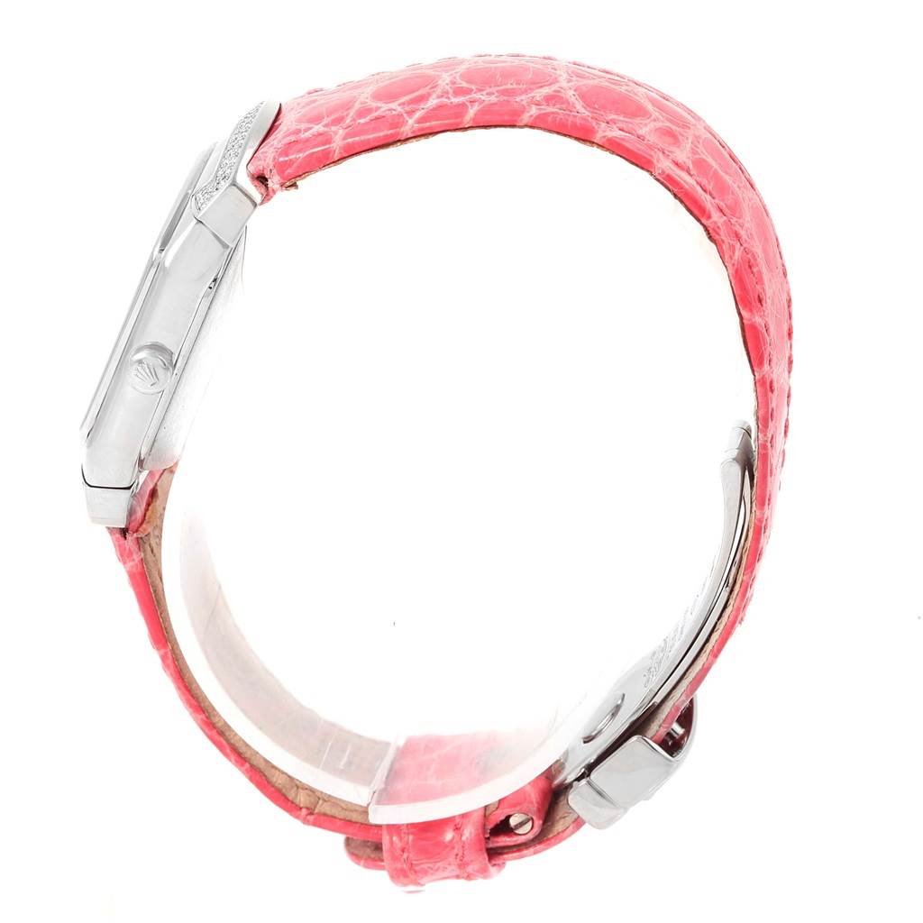 The image shows a side angle of a Rolex Cellini 6692 Women
s White Gold Pink Dial 6692 Women
s White Gold Pink Dial watch with a pink strap and silver case.