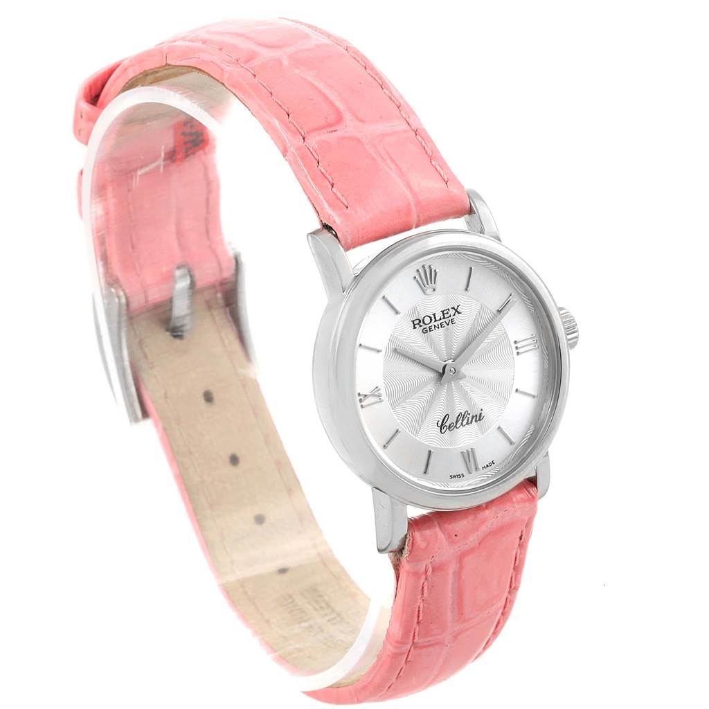 The image shows a Rolex Cellini 6110 Women
s White Gold Silver Dial 6110 Women
s White Gold Silver Dial watch with a pink leather strap, viewed from an angled perspective.
